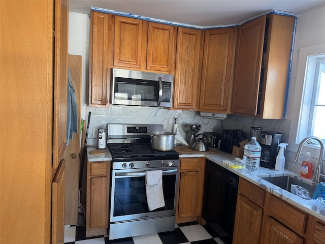 kitchen featuring a sink, appliances with stainless steel finishes, brown cabinets, light floors, and tasteful backsplash