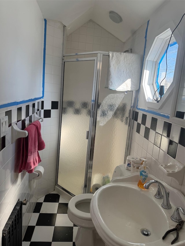 full bath featuring a shower stall, a sink, tile walls, and radiator