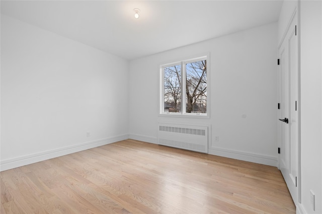 66 S Madison Ave Unit 212, Spring Valley, NY 10977 - unfurnished bedroom with light wood finished floors, radiator heating unit, and baseboards