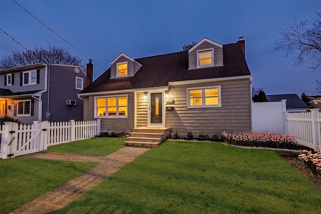 cape cod house with a chimney, a shingled roof, a front yard, a gate, and fence