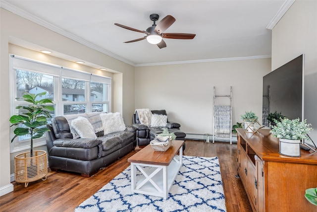 living room with a ceiling fan, crown molding, and wood finished floors