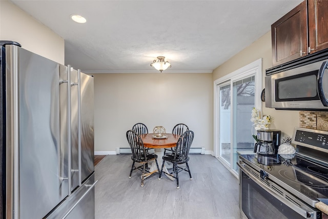 dining room featuring baseboards and baseboard heating