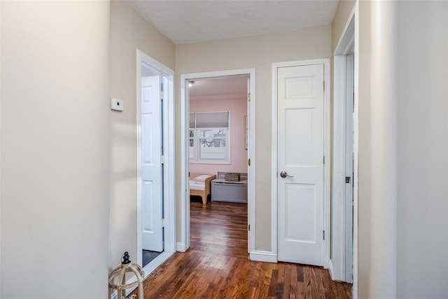 hall featuring dark wood-style floors and baseboards