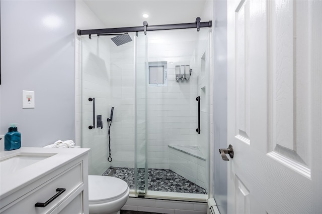 full bath featuring toilet, a stall shower, a baseboard radiator, and vanity