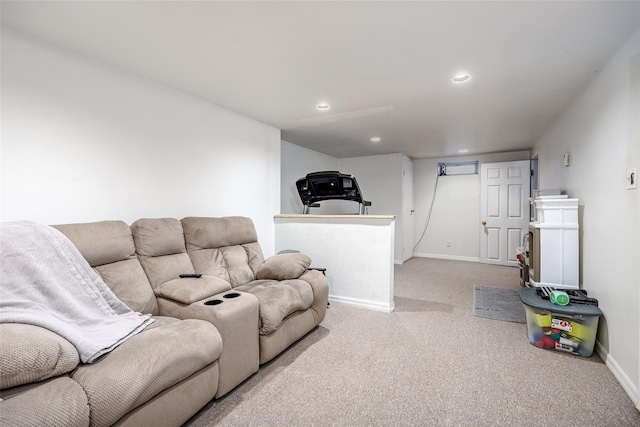 carpeted living area featuring recessed lighting and baseboards