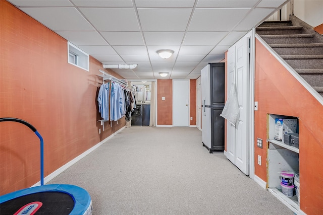 walk in closet featuring a drop ceiling and carpet