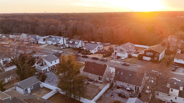 aerial view at dusk featuring a residential view