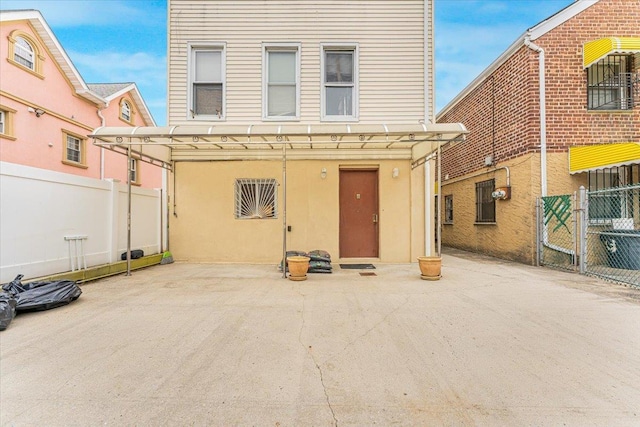 view of front facade featuring a patio area and fence