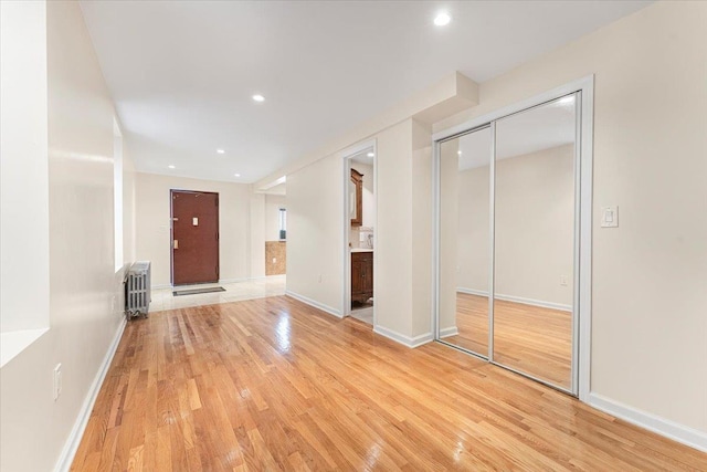 interior space featuring radiator heating unit, light wood-style flooring, and recessed lighting