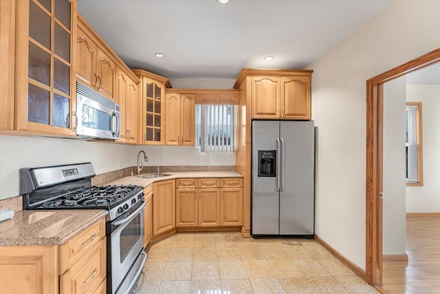 kitchen featuring appliances with stainless steel finishes, recessed lighting, a sink, and baseboards