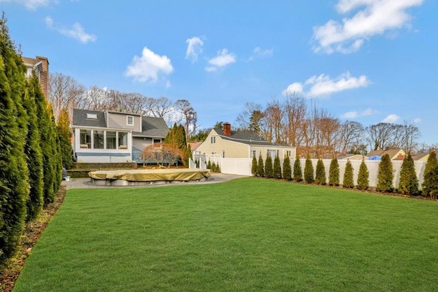 view of yard featuring a sunroom and fence