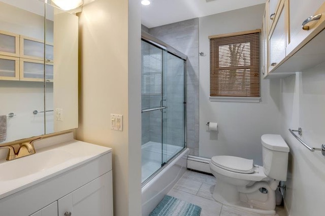 bathroom with tile patterned flooring, toilet, a baseboard heating unit, shower / bath combination with glass door, and vanity