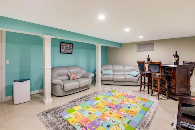 living room with tile patterned flooring, baseboards, a dry bar, and recessed lighting