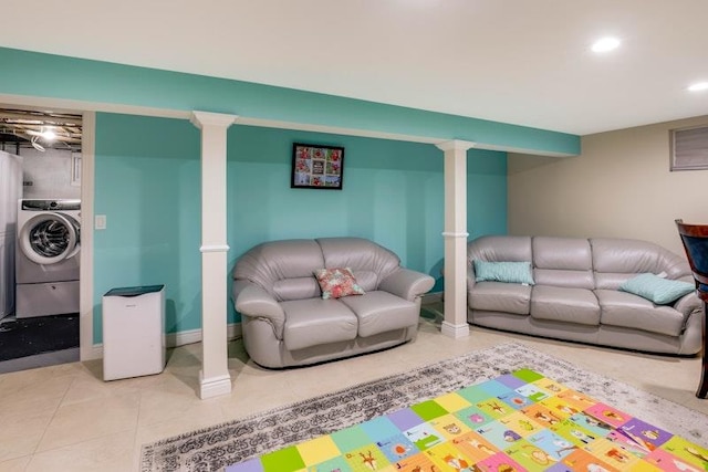 living room featuring washer / clothes dryer, recessed lighting, tile patterned flooring, and baseboards