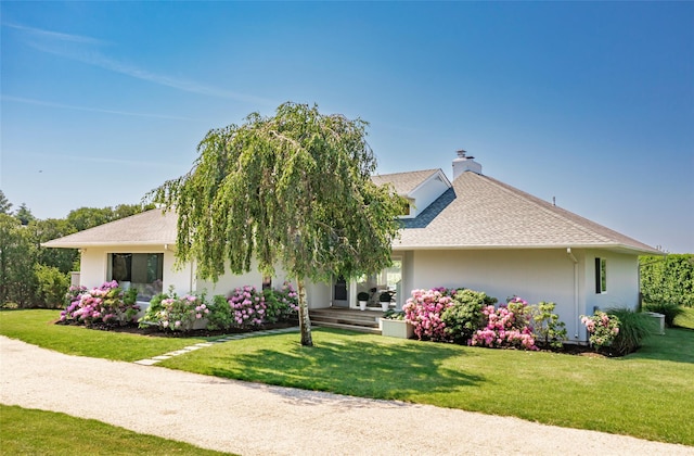 20 Winding Way, Water Mill, NY 11976 - view of front of property with stucco siding, a shingled roof, a chimney, and a front yard