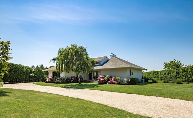 20 Winding Way, Water Mill, NY 11976 - view of front of home with driveway, stucco siding, and a front yard