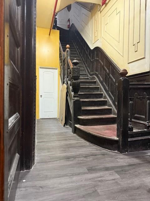 412 W 146th St, New York Manhattan, NY 10031 - stairs with wood finished floors and a towering ceiling