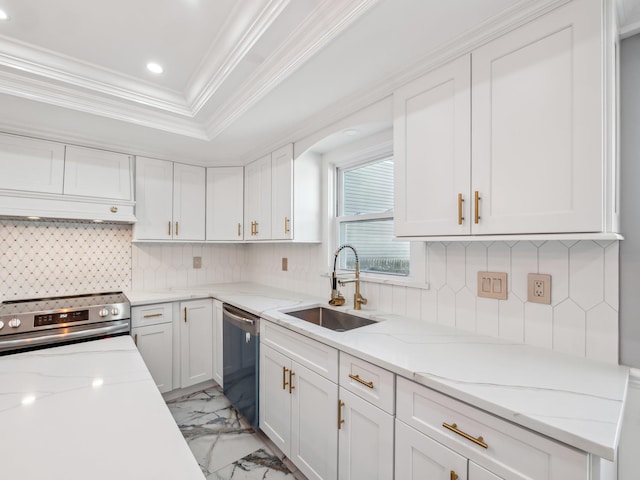 kitchen with a raised ceiling, appliances with stainless steel finishes, marble finish floor, white cabinetry, and a sink