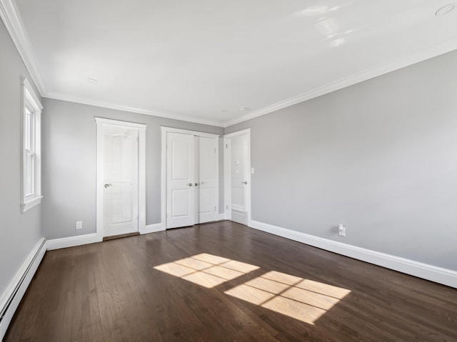 unfurnished bedroom featuring dark wood-type flooring, a baseboard radiator, crown molding, and baseboards