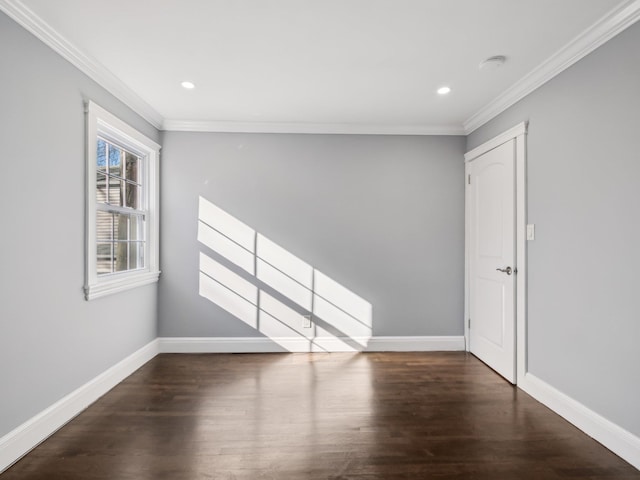 empty room featuring ornamental molding, recessed lighting, wood finished floors, and baseboards