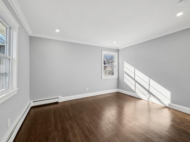 unfurnished room featuring baseboards, crown molding, a baseboard heating unit, and wood finished floors