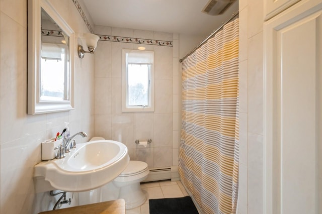 bathroom featuring visible vents, toilet, tile patterned flooring, a baseboard heating unit, and tile walls