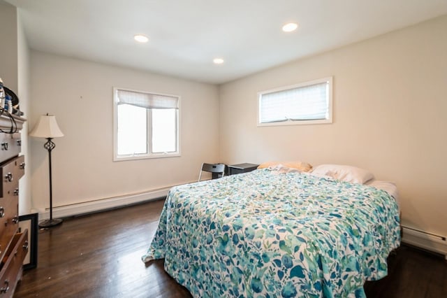 bedroom featuring multiple windows, baseboard heating, dark wood finished floors, and recessed lighting