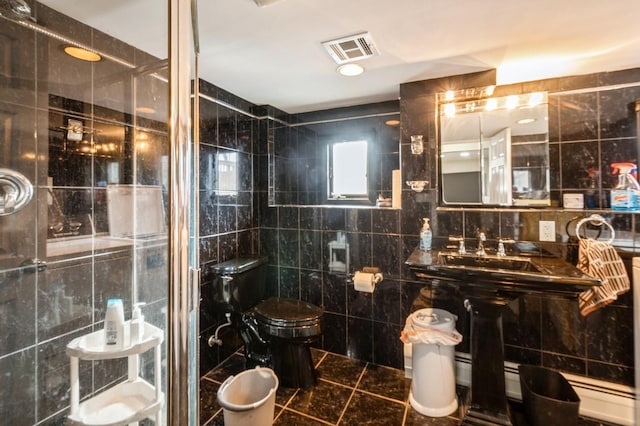 bathroom featuring a stall shower, visible vents, toilet, tile patterned floors, and tile walls