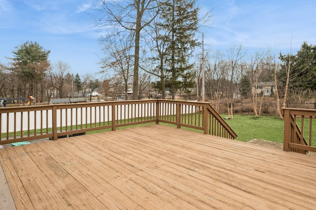 wooden terrace featuring a lawn