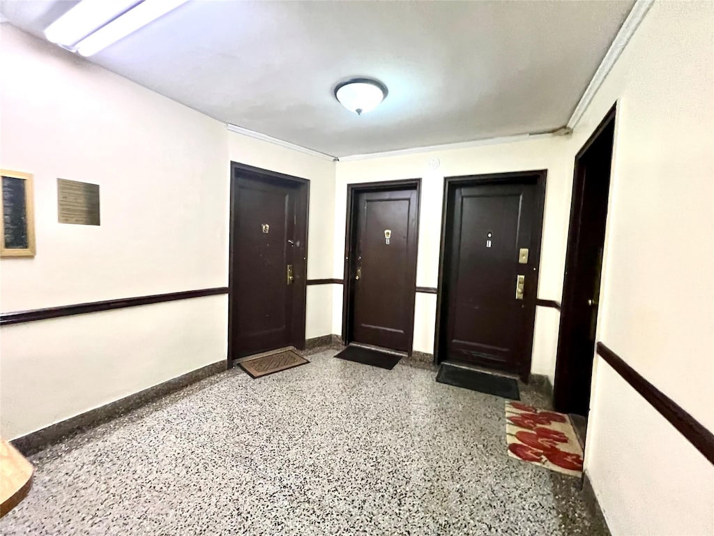 interior space featuring baseboards and speckled floor