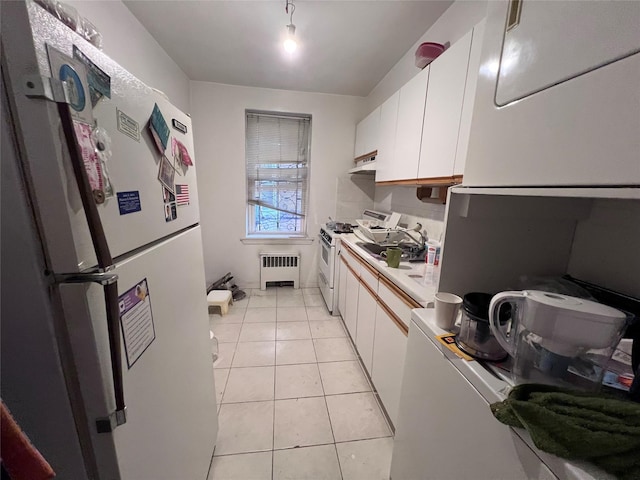 2090 Barnes Ave Unit 2H, Bronx, NY 10462 - kitchen featuring white appliances, radiator, white cabinets, under cabinet range hood, and light countertops