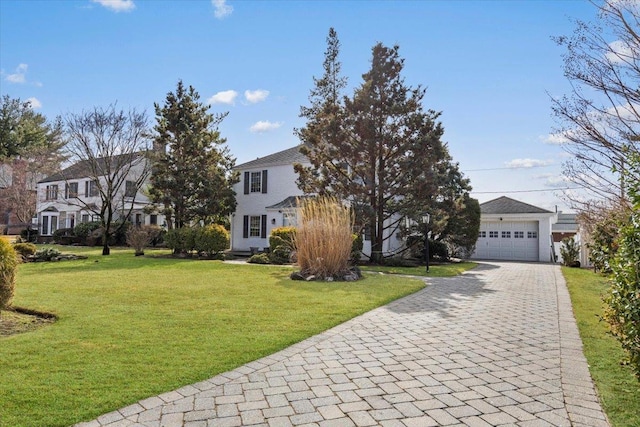 view of front facade featuring a garage, a front lawn, and decorative driveway