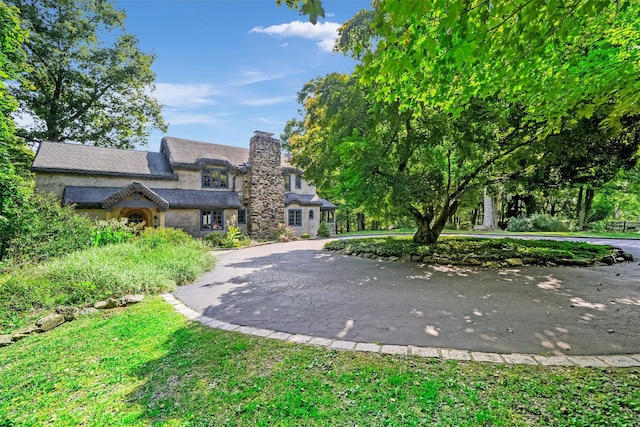 5 Shingle House Rd, Millwood, NY 10546 - view of front of home with curved driveway, stone siding, and a chimney
