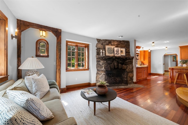 5 Shingle House Rd, Millwood, NY 10546 - living room featuring arched walkways, baseboards, a fireplace, and dark wood-type flooring