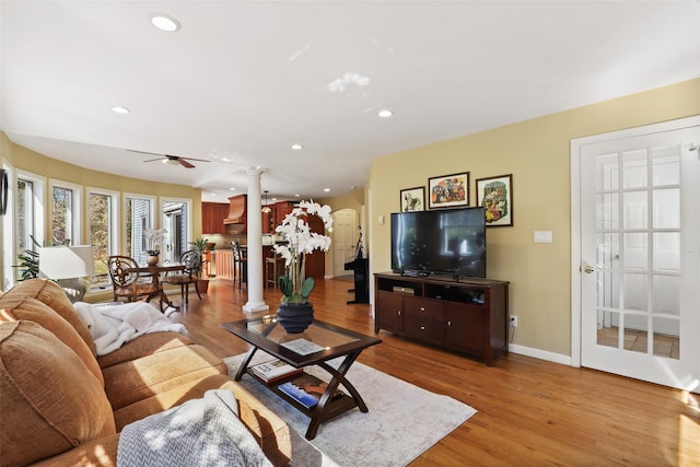 living room featuring ceiling fan, baseboards, wood finished floors, and recessed lighting