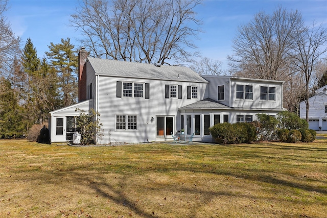 back of property featuring a yard and a chimney