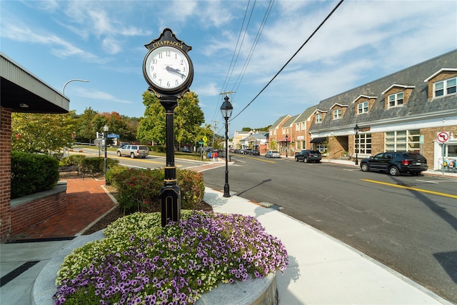 view of road featuring sidewalks, curbs, and street lighting