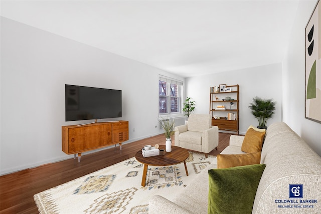 living area featuring wood finished floors and baseboards