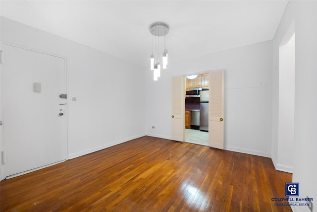 interior space with baseboards and hardwood / wood-style flooring