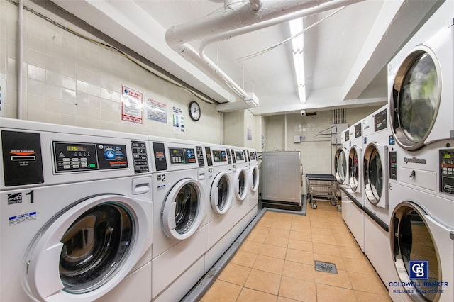 shared laundry area with light tile patterned floors, stacked washer / dryer, and washer and dryer