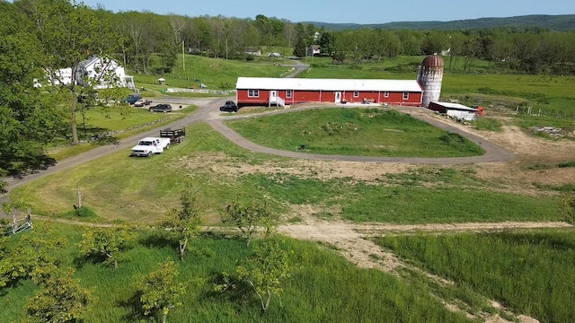 birds eye view of property featuring a rural view and a wooded view