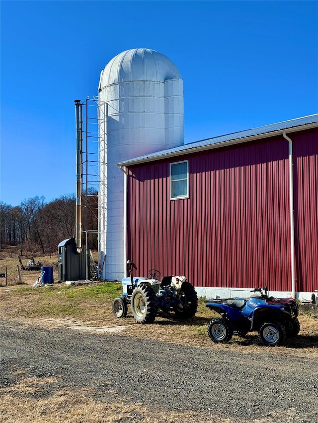 view of home's exterior with an outbuilding