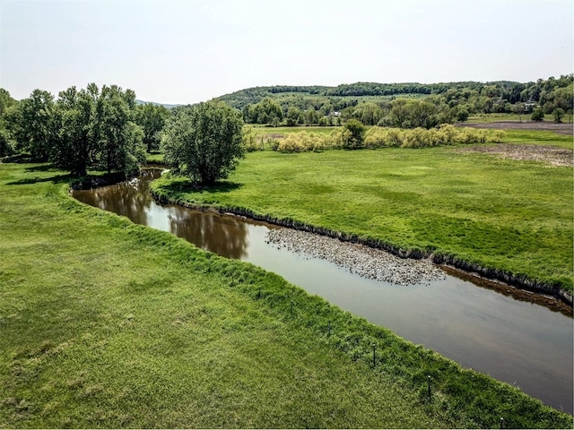 view of home's community featuring a yard and a water view