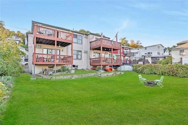 exterior space with an outdoor fire pit and a lawn