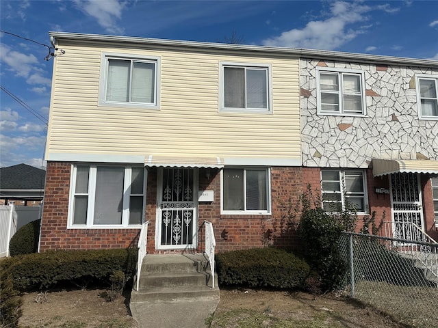 multi unit property with fence and brick siding