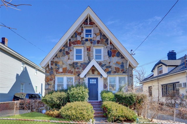 view of front of house with stone siding and fence