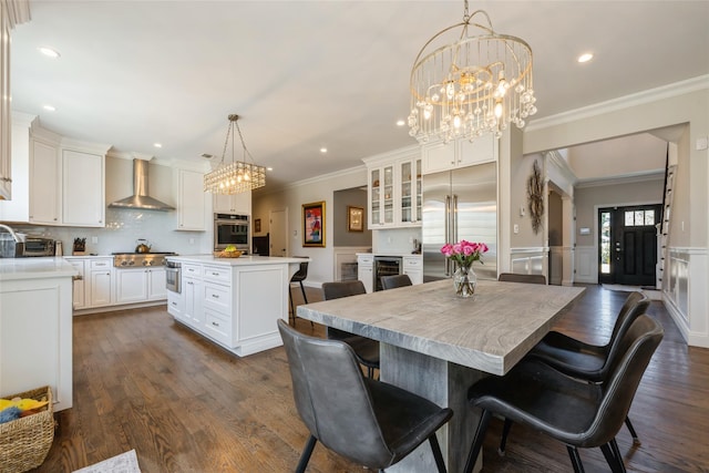 dining area featuring a wainscoted wall, ornamental molding, dark wood finished floors, and recessed lighting