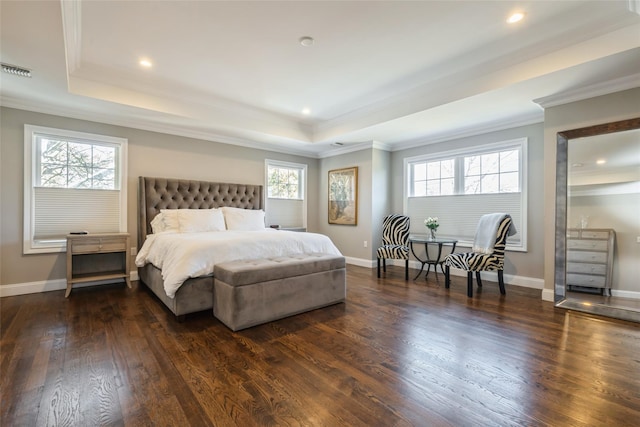 bedroom featuring dark wood-style floors, ornamental molding, a raised ceiling, and baseboards