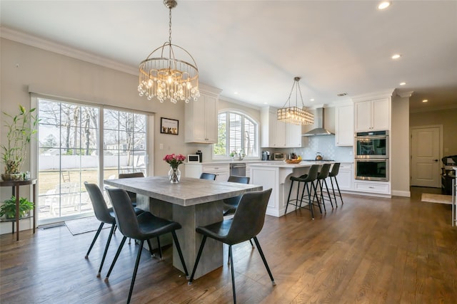 dining space featuring a chandelier, recessed lighting, dark wood-style flooring, and crown molding