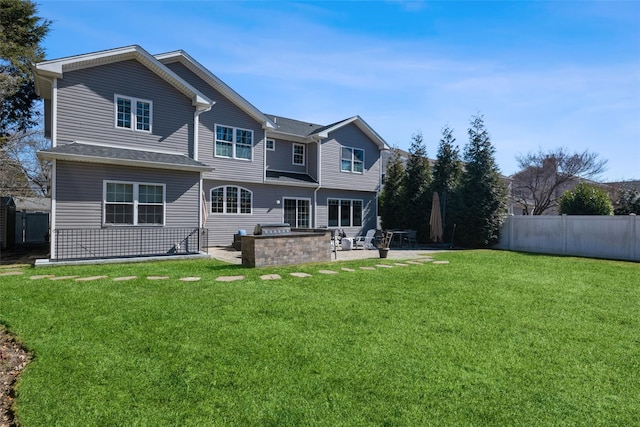 back of house featuring a patio area, fence, and a yard